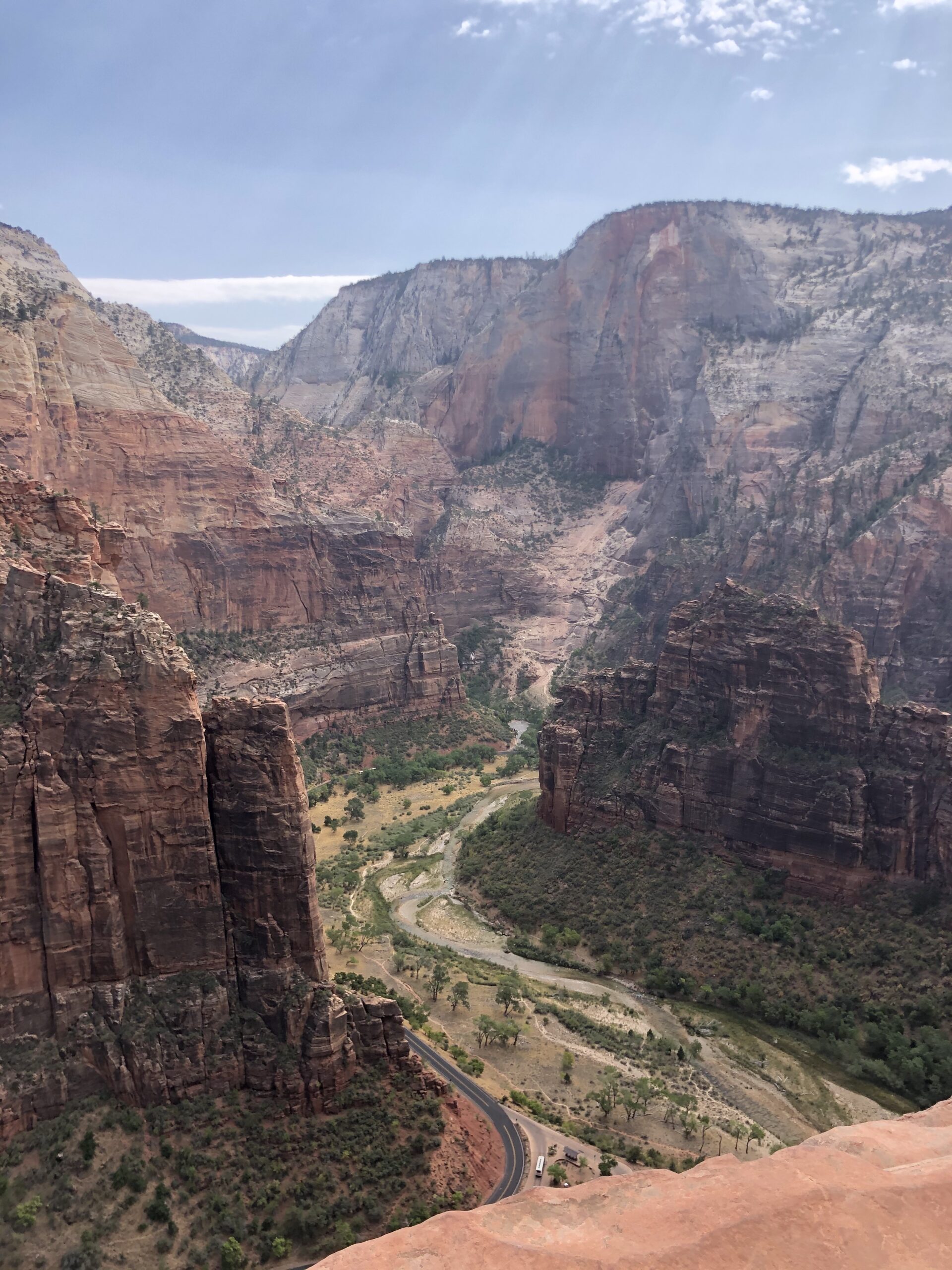 a road in between rock formations in Zion National Park