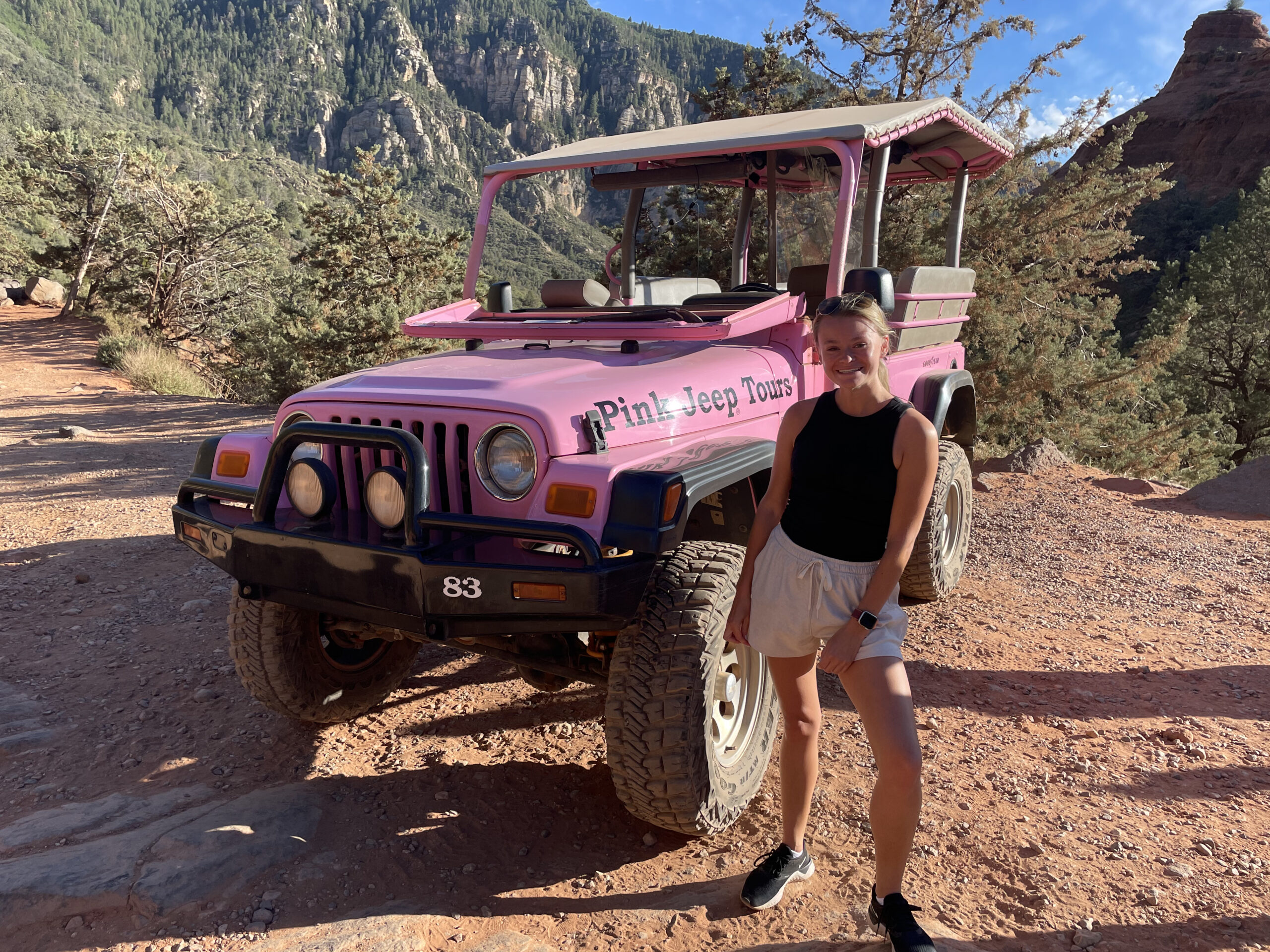 girl in front of a Pink Jeep while hiking in Sedona