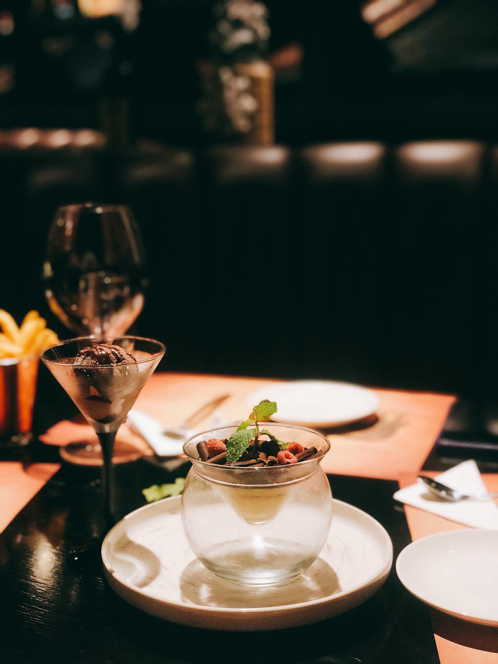 cocktail glass beside plate with cup